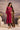 Ruby pink velvet Noor kurta set with olive striped dupatta, worn by a model